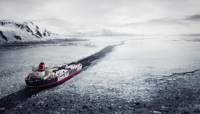 A Stena Line vessel navigating through icy waters, leaving a clear path amid a frozen landscape with snow-covered mountains.