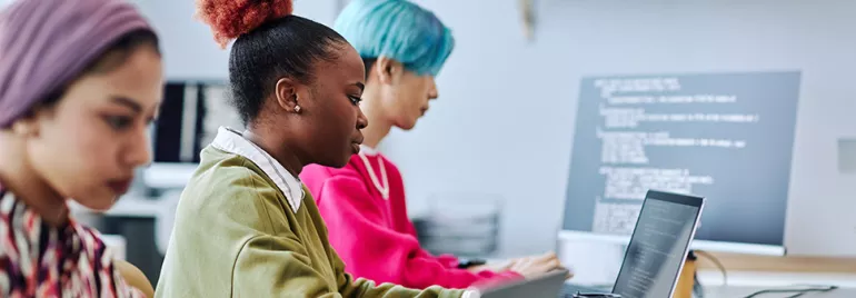 Gen Z at work on laptops in a modern office.